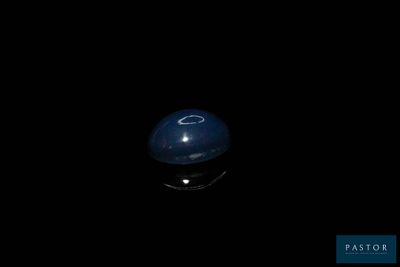 an image of a blue ball in the dark with a black background