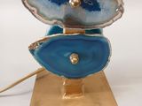 a sculpture of a blue and white agate on a gold stand
