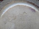 a close up of a plate with a writing on it
