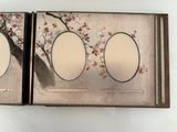 a picture of a picture of two oval mirrors in a box