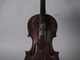 an old violin sitting on top of a white surface