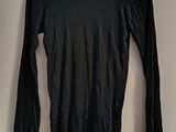 black long sleeved shirt hanging on a hanger in a room