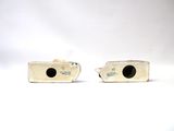 pair of white ceramic vases with black spots on them