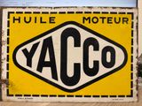 an old yellow and black sign sitting on top of a wooden table