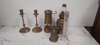 a lot of antique brass items on the table
