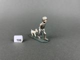 a miniature figurine of a man on a surfboard with a dog