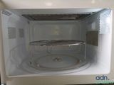 a white microwave with a glass door on the inside of it