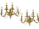 pair of antique brass wall sconces with candles on each side