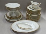 a stack of plates with a bird on top of them