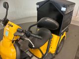 a yellow scooter with a black box on the back of it