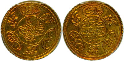two gold coins, one of which is decorated with flowers and leaves