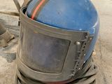 a helmet that is sitting on the ground in the garage