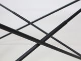 a close up of a black umbrella on a white surface