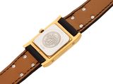 a close up of a watch on a brown leather strap