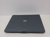 the hp laptop is sitting on a white table with a white background