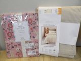 two sheets and a pillow on the table