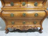 a wooden chest of drawers with brass knobs on it