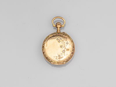 an antique gold pocket watch with a chain on a white surface