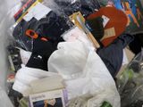 a trash can filled with clothes and other items