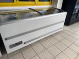 a refrigerator with a glass door in the middle of the floor