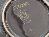 a close up of a clock on a table
