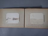 an old photo of a book opened to show a picture of a farm