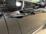 a close up of a car door handle with a sticker on it