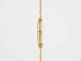a close up of a gold wrist watch on a white background