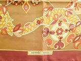 a scarf with a picture of a bird and flowers on it