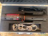 a box with a lighter and a cord in it