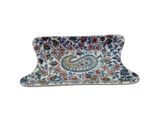 a close up of a tray with a paisley design on it