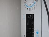 a close up of a washing machine with the door open