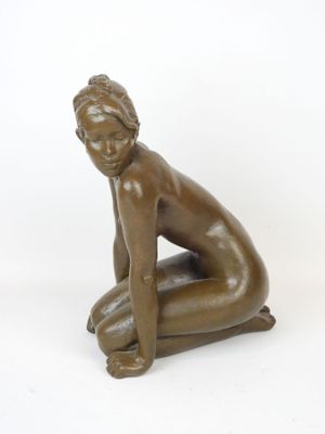 bronze statue of a woman kneeling on her knees