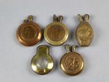 four gold and silver lockes with medallions on them on a white surface