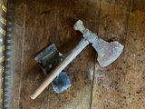 un marteau et une vieille hache posés sur un plancher en bois