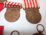 two medals and a pair of scissors on a table