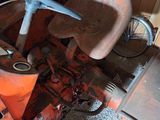 an old tractor that is sitting in a garage