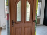 a wooden door with a glass window in the middle of a room