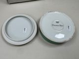 a white bowl and a green bowl sitting on a table