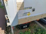 a white refrigerator sitting on the side of the road