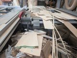 a man that is working on a machine in a woodworking shop