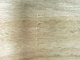 a close up of a piece of wood with some writing on it