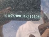 a reflection of a person holding a cell phone in front of a window