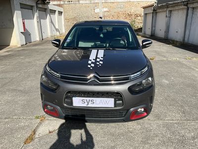 the car is parked in the parking lot with a number plate on it