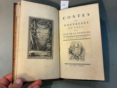 someone is holding an open book with a picture of a woman on it