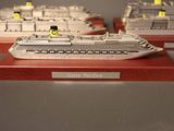 three model ships that are on display on a table