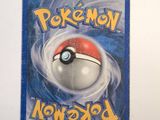 a card with a pokemon figure on it on a table