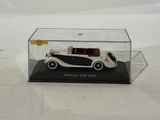 a white and black model of a car in a clear box