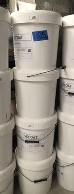 several white buckets stacked on top of each other in a warehouse