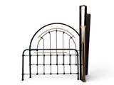 a bed with a metal frame and umbrellas on it